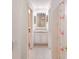 Bright hallway bathroom featuring a vanity, mirror, and a flamingo-themed shower curtain at 4410 67Th Avenue E Cir, Sarasota, FL 34243
