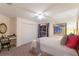 Cozy bedroom featuring neutral walls, a ceiling fan, closet, and a quaint desk area at 4410 67Th Avenue E Cir, Sarasota, FL 34243