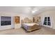 Bright bedroom with ceiling fan, hardwood floors, and natural light showcasing a relaxing retreat at 4410 67Th Avenue E Cir, Sarasota, FL 34243