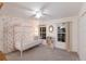 Charming bedroom with a four-poster bed, floral wallpaper, and natural light, perfect for a  at 4410 67Th Avenue E Cir, Sarasota, FL 34243