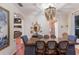 Formal dining room with elegant chandelier, hardwood floors, and stylish decor showcasing a welcoming space at 4410 67Th Avenue E Cir, Sarasota, FL 34243