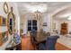 Formal dining room with elegant chandelier, hardwood floors, and stylish decor showcasing a welcoming space at 4410 67Th Avenue E Cir, Sarasota, FL 34243