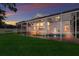 Back exterior of home with a pool, patio, and lush green lawn, perfect for outdoor living and entertainment at 4410 67Th Avenue E Cir, Sarasota, FL 34243