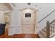 Inviting foyer with staircase, decorative columns, tile flooring, and a view of the front entrance at 4410 67Th Avenue E Cir, Sarasota, FL 34243