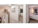 Hallway with gray carpet leading to bedrooms, showcasing the home's layout and design at 4410 67Th Avenue E Cir, Sarasota, FL 34243
