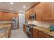 Well-equipped kitchen with granite countertops, stainless steel appliances, and ample cabinet space at 4410 67Th Avenue E Cir, Sarasota, FL 34243