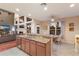 Open kitchen with a breakfast bar, stainless steel appliances, and a view of the living room at 4410 67Th Avenue E Cir, Sarasota, FL 34243