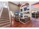 Bright living room with a fireplace, high ceilings, staircase, and comfortable seating area at 4410 67Th Avenue E Cir, Sarasota, FL 34243