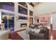 Open living room featuring a stone fireplace, high ceilings, and views of the pool area at 4410 67Th Avenue E Cir, Sarasota, FL 34243