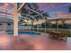 Screened-in pool area with outdoor seating and sunset views, perfect for entertaining and relaxation at 4410 67Th Avenue E Cir, Sarasota, FL 34243