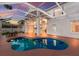 Inviting screened-in pool with connected patio and shaded table for outdoor relaxation at 4410 67Th Avenue E Cir, Sarasota, FL 34243