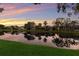 Scenic water view of homes reflecting in a tranquil lake at sunset, offering a peaceful neighborhood view at 4410 67Th Avenue E Cir, Sarasota, FL 34243
