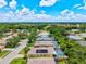 View of a quiet neighborhood featuring homes with lush landscapes, swimming pools, and beautiful blue skies at 5004 Creekside Trl, Sarasota, FL 34243