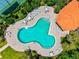 Overhead view of a community pool area with a cabana and well-maintained landscaping at 5004 Creekside Trl, Sarasota, FL 34243