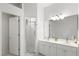 A bathroom with bright white cabinets and a sleek glass shower at 5004 Creekside Trl, Sarasota, FL 34243