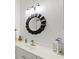 Bright bathroom featuring a white countertop, sink, decorative mirror and wall lighting at 5004 Creekside Trl, Sarasota, FL 34243