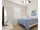 Bedroom with a blue comforter on a white frame, complete with a TV at 5004 Creekside Trl, Sarasota, FL 34243