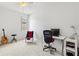 This room is complete with a guitar and chair beside the desk, ready for focused practice at 5004 Creekside Trl, Sarasota, FL 34243