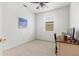 Clean and bright bedroom featuring neutral carpet, a window, and a desk area at 5004 Creekside Trl, Sarasota, FL 34243