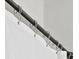 Close-up of a dark curtain rail and white, see through curtains at 5004 Creekside Trl, Sarasota, FL 34243