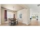 Cozy dining room with a modern chandelier and serene view of the outdoors at 5004 Creekside Trl, Sarasota, FL 34243