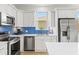 Bright modern kitchen with stainless steel appliances, quartz countertops, and stylish white cabinets for a clean, contemporary look at 5004 Creekside Trl, Sarasota, FL 34243