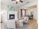Cozy living space featuring a fireplace, wood floors, and an adjacent dining area at 5004 Creekside Trl, Sarasota, FL 34243
