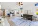 A well lit living room and kitchen area with stainless steel appliances and hardwood floors at 5004 Creekside Trl, Sarasota, FL 34243