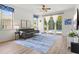 Bright living room with light wood floors, stylish furnishings, and sliding glass doors that open to a screened pool area at 5004 Creekside Trl, Sarasota, FL 34243