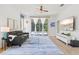 Comfortable living room with neutral decor, a ceiling fan, and sliding glass doors leading to the pool area for indoor-outdoor living at 5004 Creekside Trl, Sarasota, FL 34243