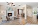 Open-concept living area with fireplace, hardwood floors, and seamless flow to dining and outdoor spaces at 5004 Creekside Trl, Sarasota, FL 34243
