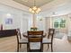 Open-concept living and dining room features wood floors, neutral walls, and natural light, creating a welcoming and airy space at 5004 Creekside Trl, Sarasota, FL 34243