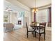 Bright living room with a cozy fireplace and an adjacent dining area with wood floors and plenty of natural light at 5004 Creekside Trl, Sarasota, FL 34243