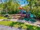Community playground area featuring fun activities, a picnic table, and trees for shade at 5004 Creekside Trl, Sarasota, FL 34243