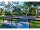 Inviting playground with a bench and play equipment, surrounded by mature trees and green grass at 5004 Creekside Trl, Sarasota, FL 34243