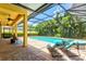 Inviting screened-in pool area with brick pavers and comfortable lounge seating at 5004 Creekside Trl, Sarasota, FL 34243