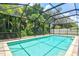 Relaxing backyard pool area with screened enclosure and lush tropical landscaping at 5004 Creekside Trl, Sarasota, FL 34243