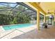 Beautiful screened-in pool area with brick pavers and relaxing lounge chairs at 5004 Creekside Trl, Sarasota, FL 34243