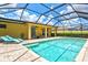 Enjoy a refreshing pool experience right outside your door with a sunny deck, covered patio and bright yellow home exterior at 5004 Creekside Trl, Sarasota, FL 34243