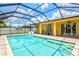 Beautiful backyard pool with screened enclosure, patio, and outdoor seating at 5004 Creekside Trl, Sarasota, FL 34243