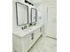 Bright bathroom with double sink vanity, modern fixtures and marble floor at 5009 Jody Ave, North Port, FL 34288