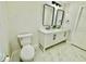 Bright bathroom with double sink vanity, modern fixtures and marble floor at 5009 Jody Ave, North Port, FL 34288