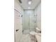 Modern bathroom featuring a glass-enclosed shower with stylish tile and a new commode at 5009 Jody Ave, North Port, FL 34288