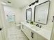 Bathroom featuring double sinks, modern fixtures, and elegant marble flooring at 5009 Jody Ave, North Port, FL 34288