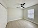 Bright bedroom with light gray walls, and natural light from the large window at 5009 Jody Ave, North Port, FL 34288