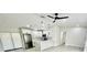 Kitchen featuring stainless steel appliances, white cabinetry, granite countertops, and a fan against a bright room at 5009 Jody Ave, North Port, FL 34288