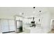 Open-concept kitchen with stainless steel appliances, white cabinetry, granite counters, and stylish pendant lighting at 5009 Jody Ave, North Port, FL 34288