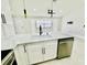 Modern kitchen featuring a spacious island with white cabinets, stainless steel appliances, and ample counter space at 5009 Jody Ave, North Port, FL 34288