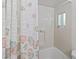 Bright bathroom featuring a seashell patterned shower curtain and tub with white tile surround at 508 50Th Avenue W Plz, Bradenton, FL 34207