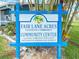 The Fair Lane Acres 55+ community center sign displaying community values and participation with foliage surround at 508 50Th Avenue W Plz, Bradenton, FL 34207